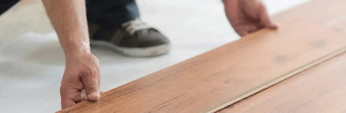 A professional installing laminate flooring in Sarasota, FL